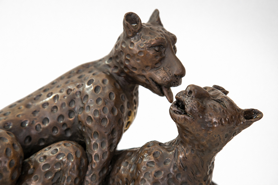 Leopard sculpture family interaction